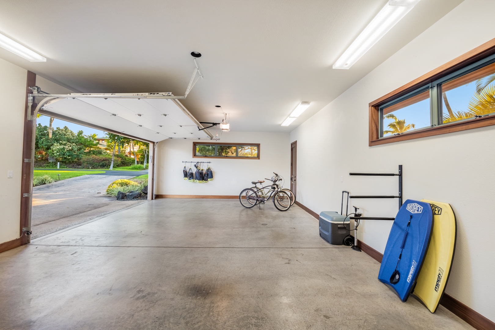 Kamuela Vacation Rentals, Champion Ridge Elegance - Spacious two-car garage featuring neatly stored sports equipment and secure parking.
