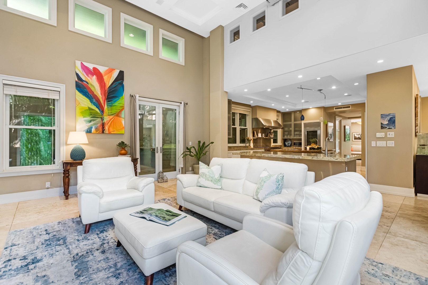 Honolulu Vacation Rentals, Pili Pono - Contemporary living room with luxe white couches and vibrant art.