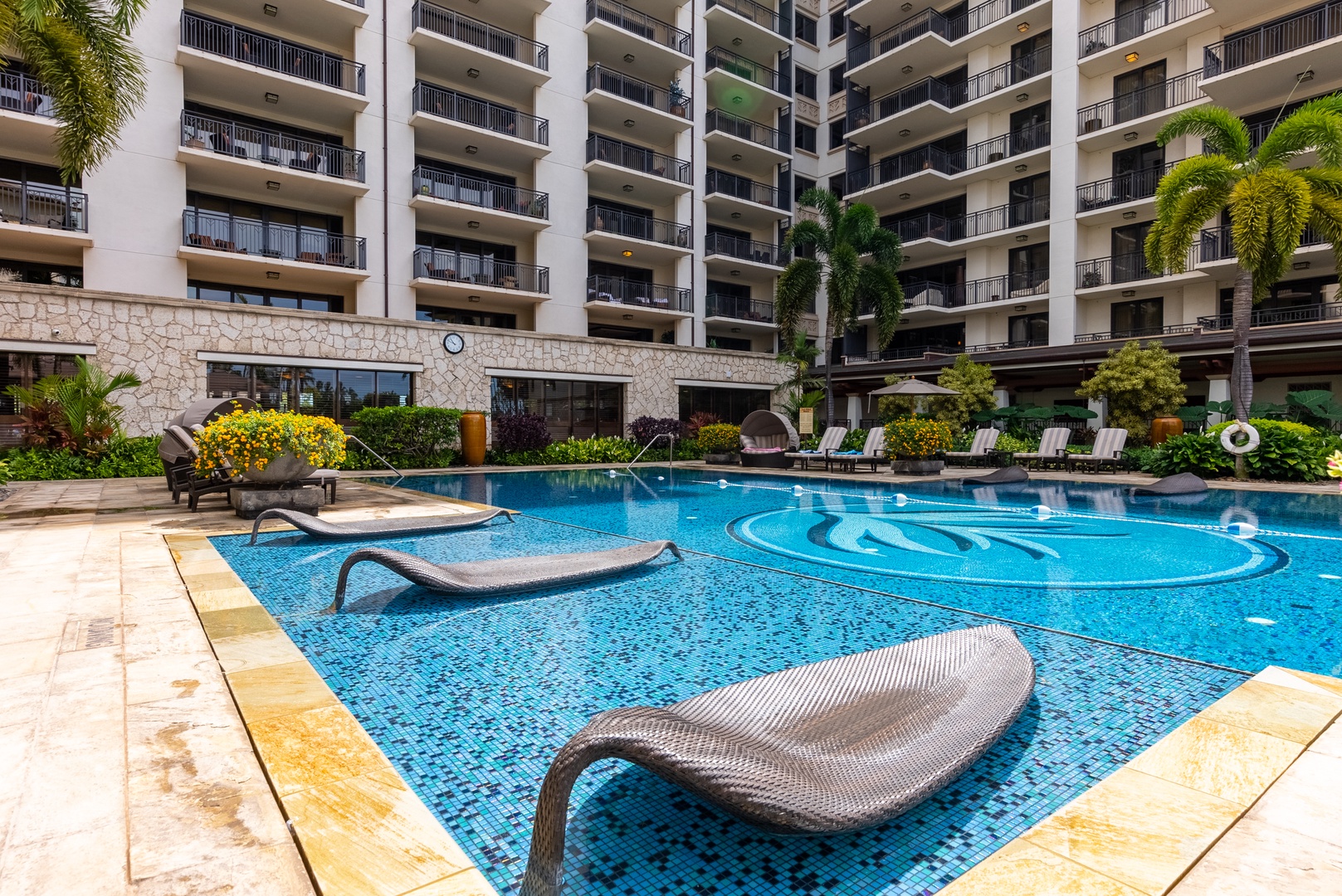 Stretch out on the in-water chaise, half in the shallow end.