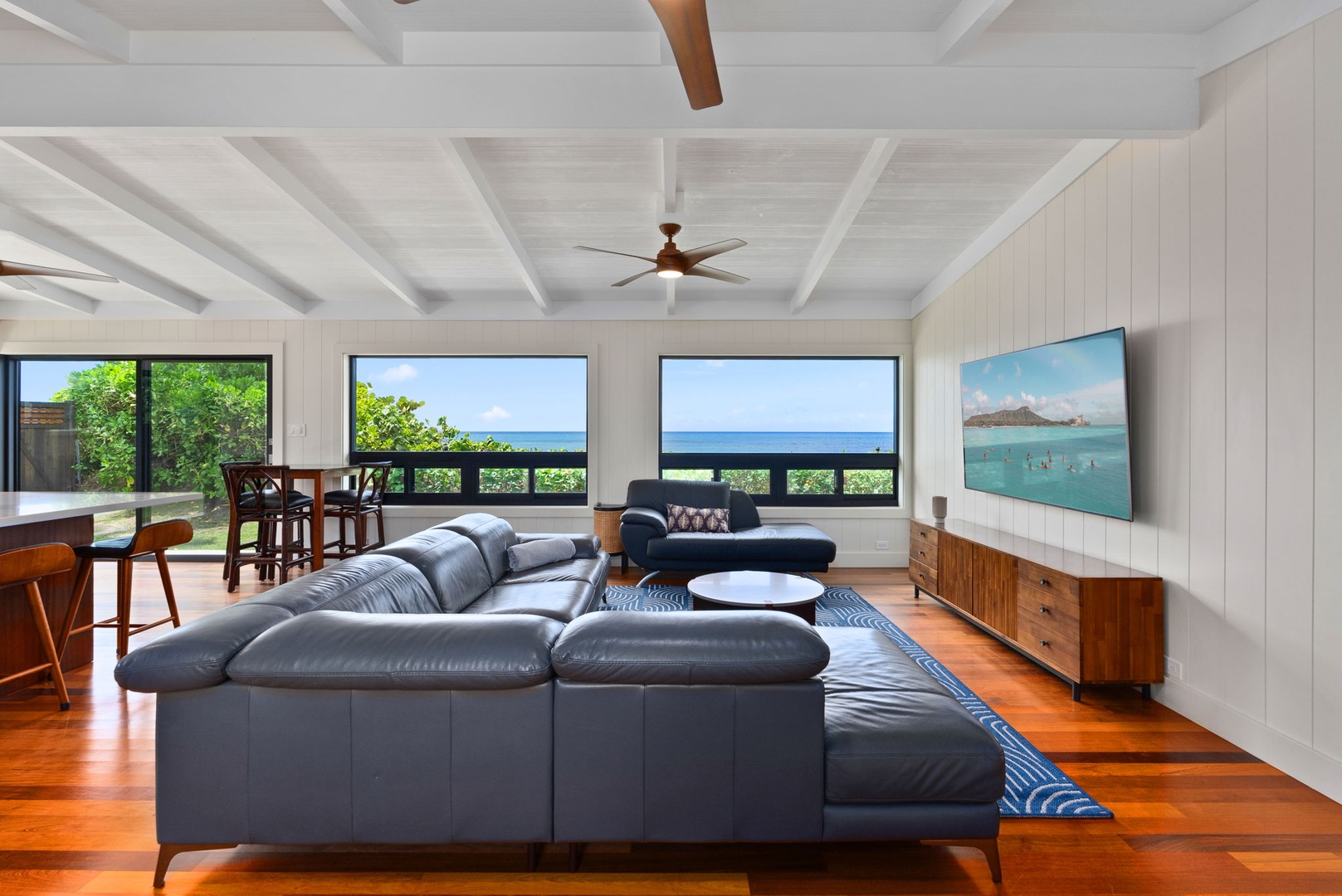 Waialua Vacation Rentals, Mokuleia Beach Villa** - Relax in the living area with large windows and ocean views.