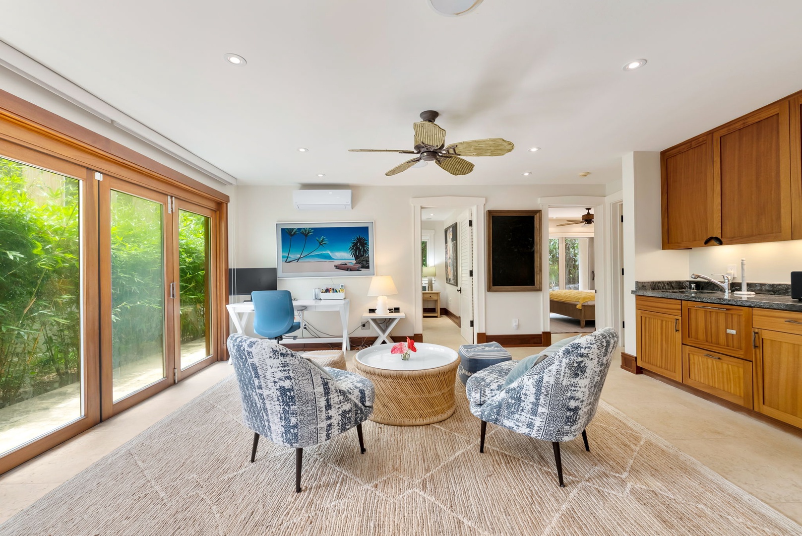 Kailua Vacation Rentals, Leaf House - Cozy and airy living space with tropical ceiling fan, AC, and lush garden views. The kitchenette and workspace blend comfort with convenience for your perfect getaway.