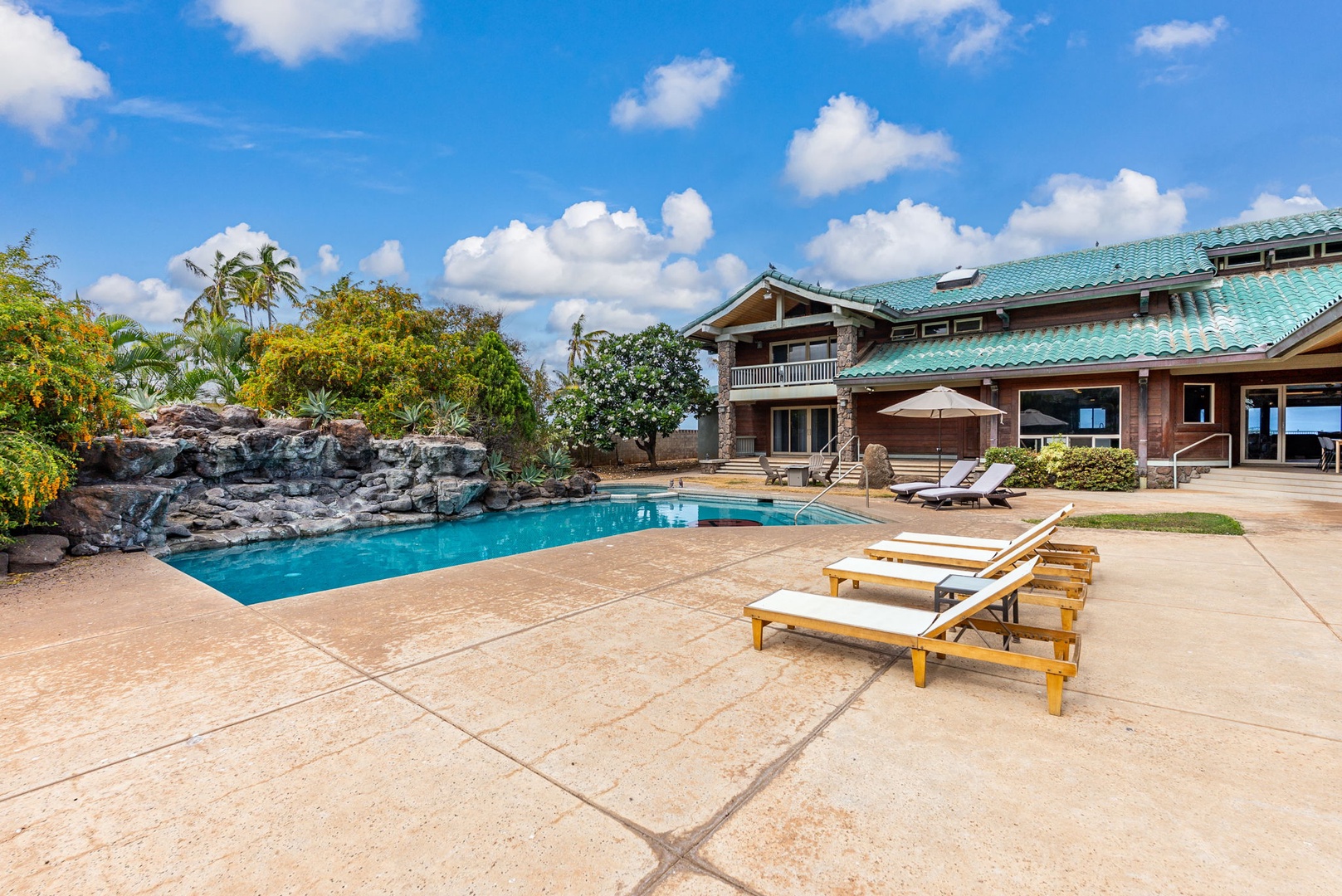 Waianae Vacation Rentals, Konishiki Beachhouse - 4BD - Spacious pool deck perfect for lounging under the Hawaiian sun.