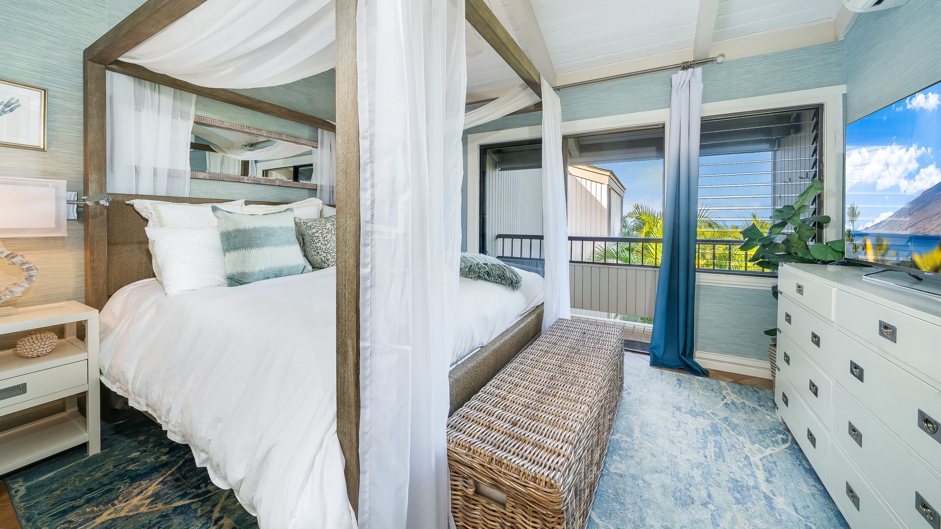 Kihei Vacation Rentals, Wailea Ekolu 1106 - This cozy bedroom features a luxurious canopy bed with soft drapery, perfect for enjoying a peaceful night's sleep while soaking in the fresh island air from the nearby lanai.