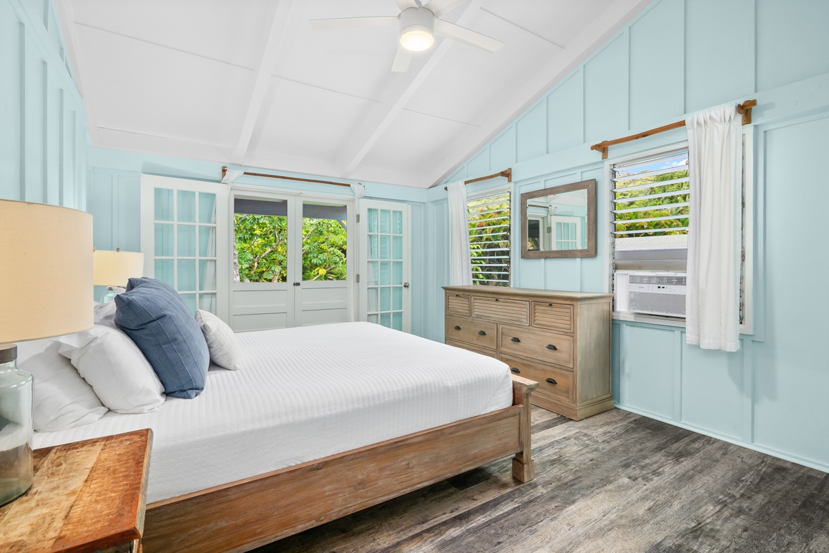 Hanalei Vacation Rentals, Hale Kanani (Kaua'i) TVNC 1342 - The primary bedroom wears soft teal, its bed dressed in blues that echo the island outside.