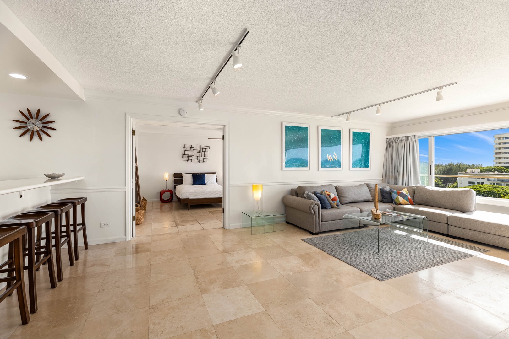 Honolulu Vacation Rentals, Colony Surf Getaway - Open-concept layout featuring a comfortable living area that flows into a cozy bedroom, ideal for rest and relaxation.
