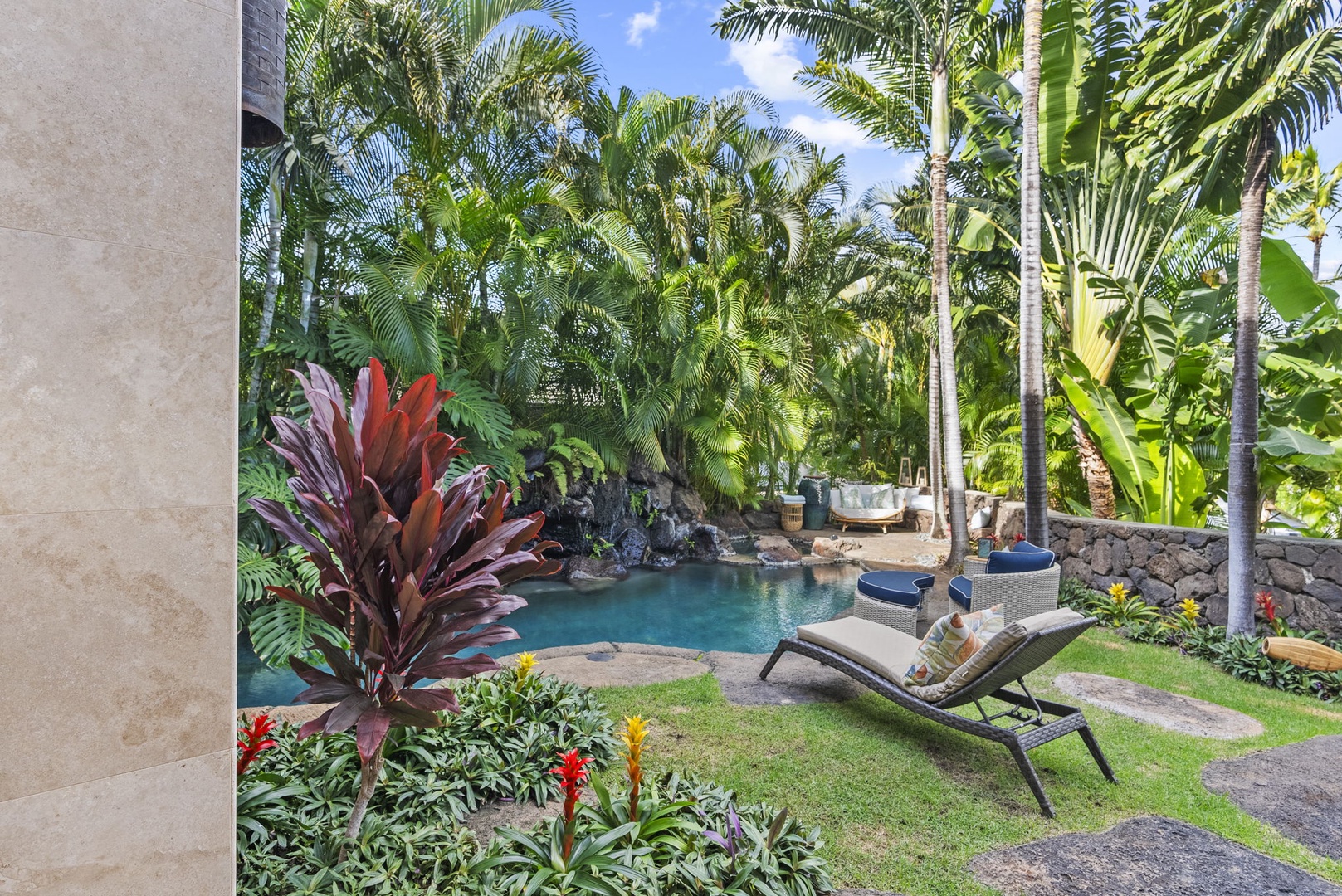 Honolulu Vacation Rentals, Pili Pono - Relaxing outdoor space with poolside seating and lush greenery.