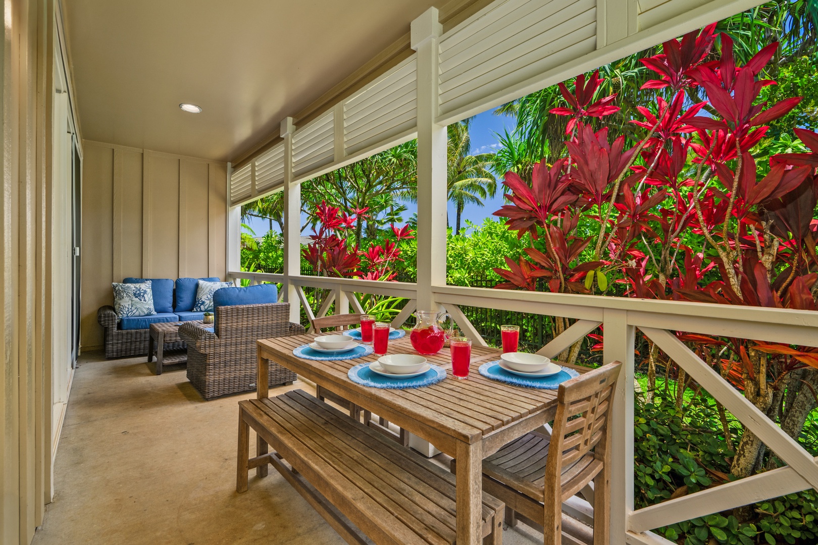 Princeville Vacation Rentals, Kaimana Villa - Step onto your covered lanai where tropical breezes meet comfortable seating and a dining table perfectly set for memorable meals.