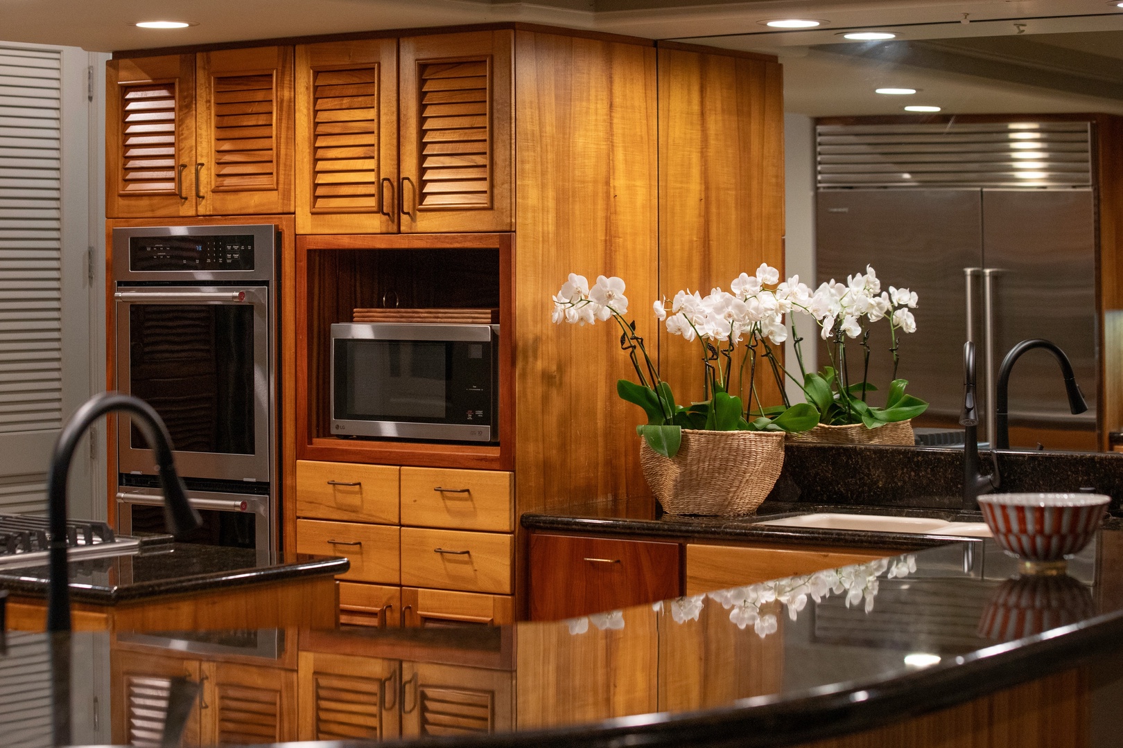 Kamuela Vacation Rentals, Canoe House at Champion Ridge - Double ovens, ample counter space, and tropical blooms make every meal feel special.
