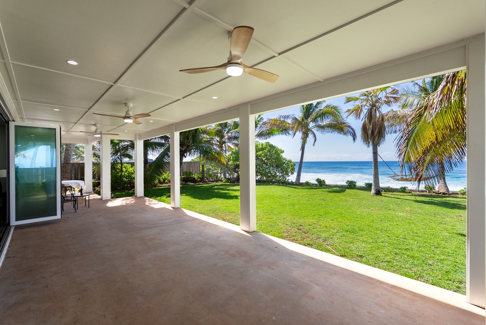 Waianae Vacation Rentals, Oceanfront Luxury Dream Estate - A long, covered lanai stretches along the lawn—ideal for yoga, reading, or shaded afternoon lounging.