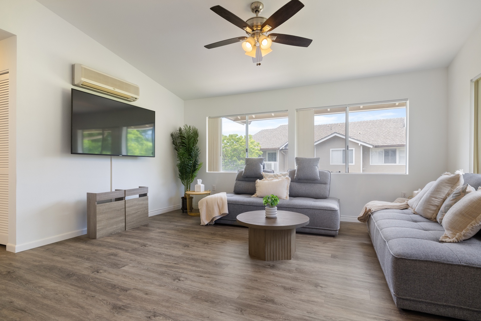 Kapolei Vacation Rentals, Fairways at Ko Olina 7A - Unwind in your bright, modern living space with plush sectional seating, smart TV entertainment, and refreshing air conditioning for ultimate comfort.