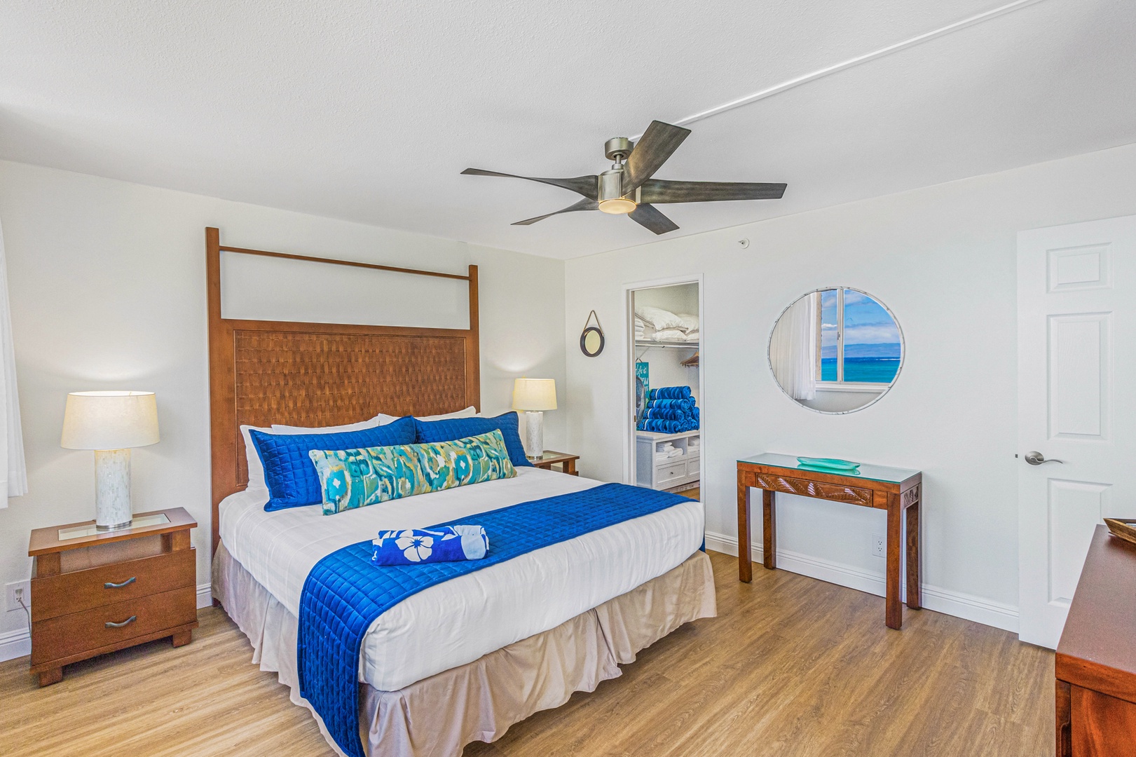 Lahaina Vacation Rentals, Royal Kahana 213 - The primary bedroom offers a cozy king bed, vibrant décor, and a relaxing atmosphere, with easy access to the ensuite bathroom.