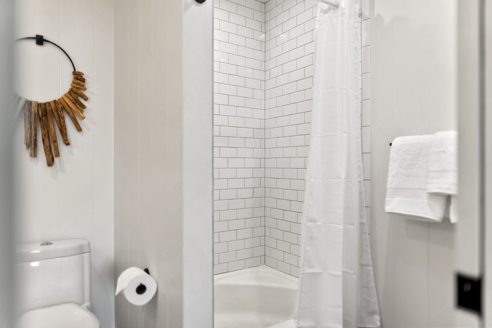 Honolulu Vacation Rentals, Honolulu Beachfront Retreat - Bright shower space with classic subway tile, offering a refreshing place to rinse after a day at the beach.