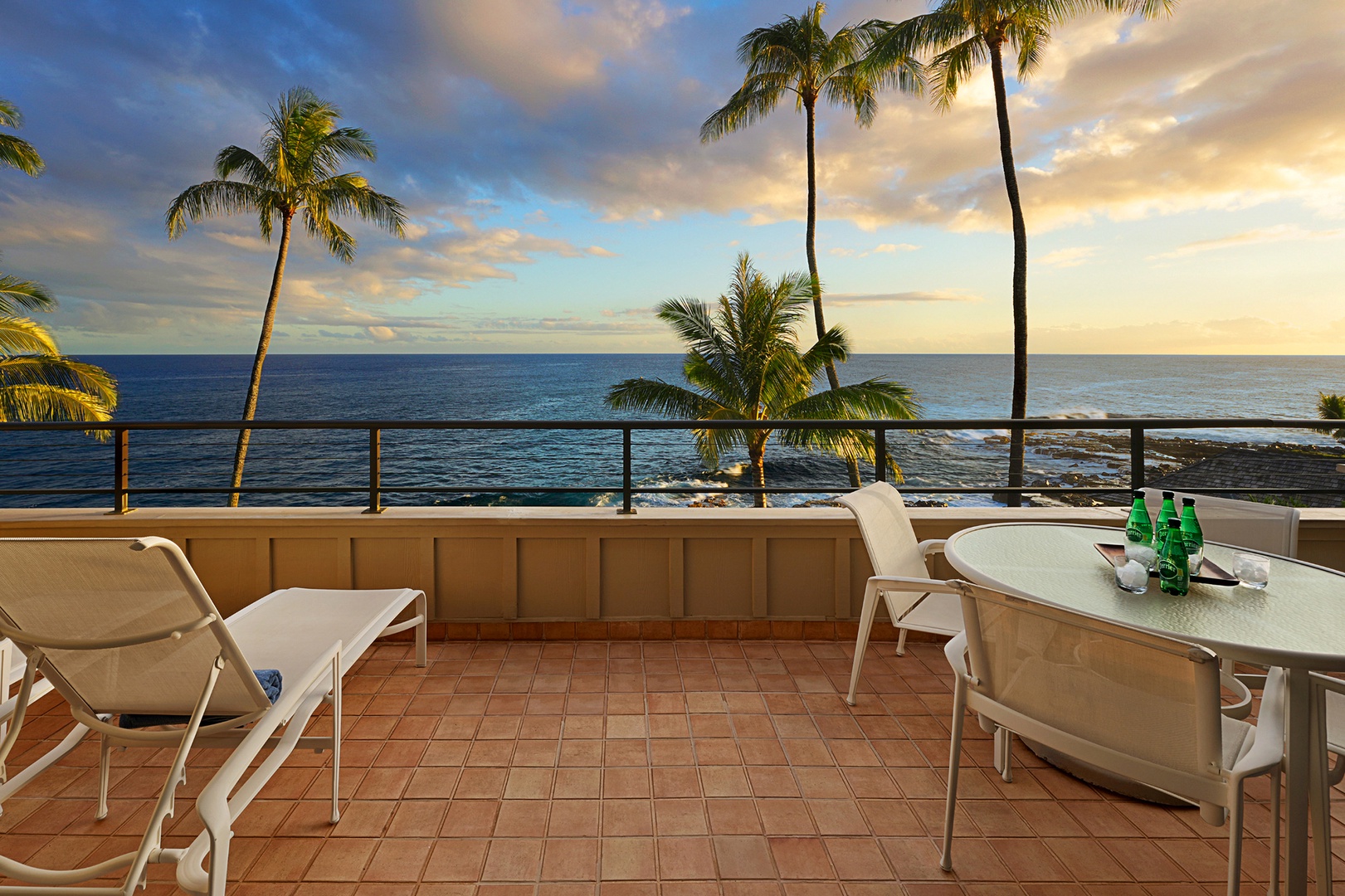 Koloa Vacation Rentals, Whalers Cove #133 - Unwind on the oceanfront lanai with seating for four and two lounge chairs—perfect for sunset views and relaxing by the waves.