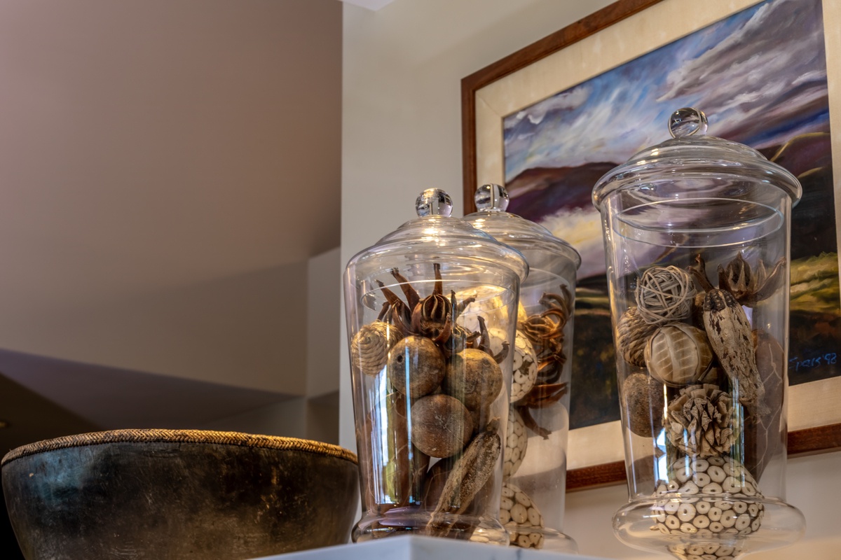 Kailua Kona Vacation Rentals, Fairways Villa 120A - Your retreat features thoughtfully curated glass displays of natural treasures, creating a serene coastal ambiance that invites relaxation.