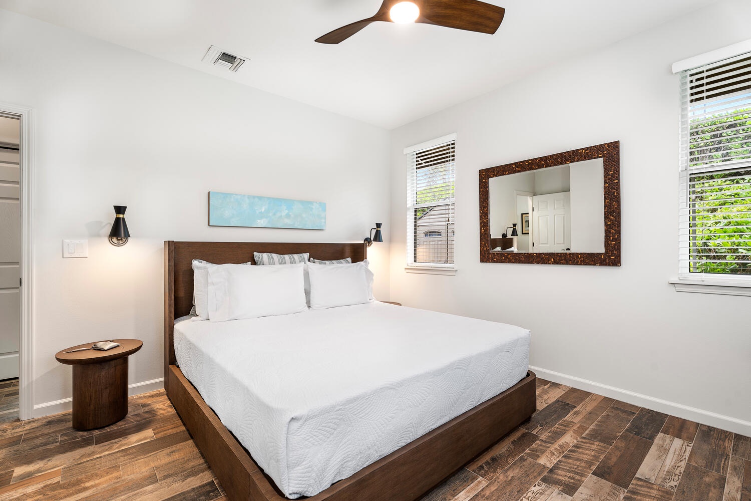 Kailua Kona Vacation Rentals, Kahakai Estates Hale - Guest Suite 1 with a plush queen bed, ceiling fan, and bright windows.