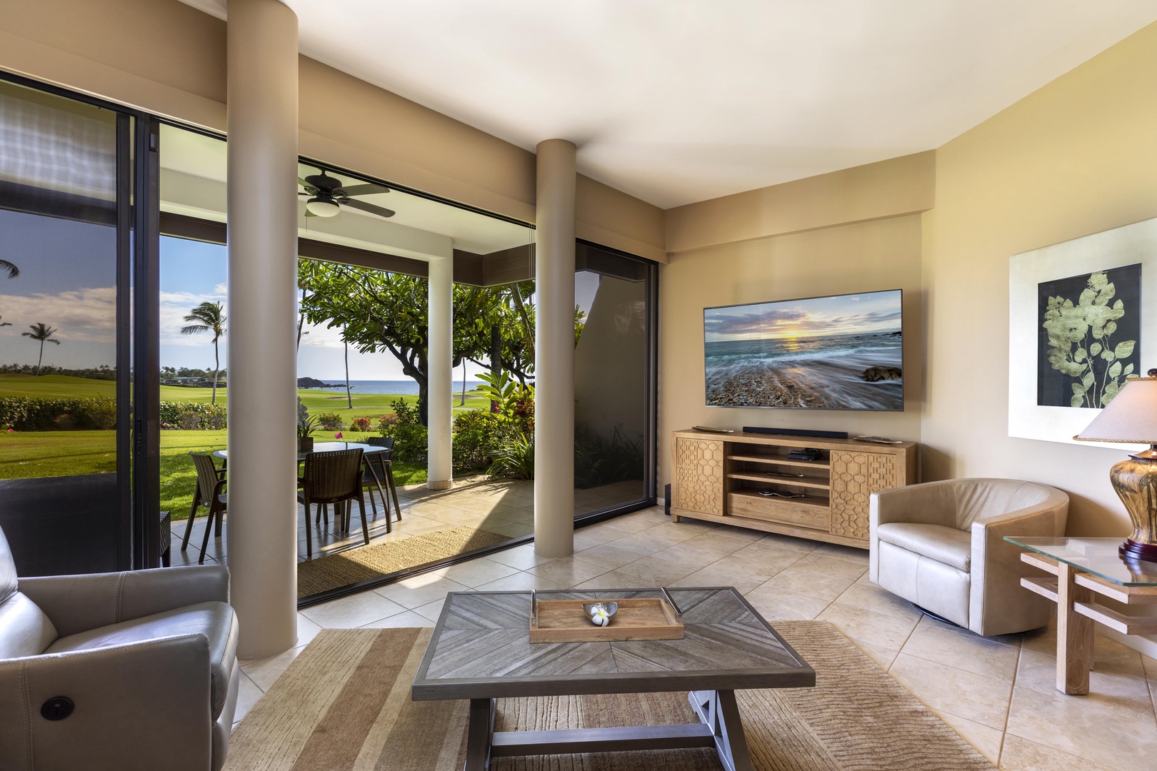 Kamuela Vacation Rentals, Mauna Lani Point E105 - Enjoy the airy great room with sweeping views of the golf course and the crashing waves just beyond.