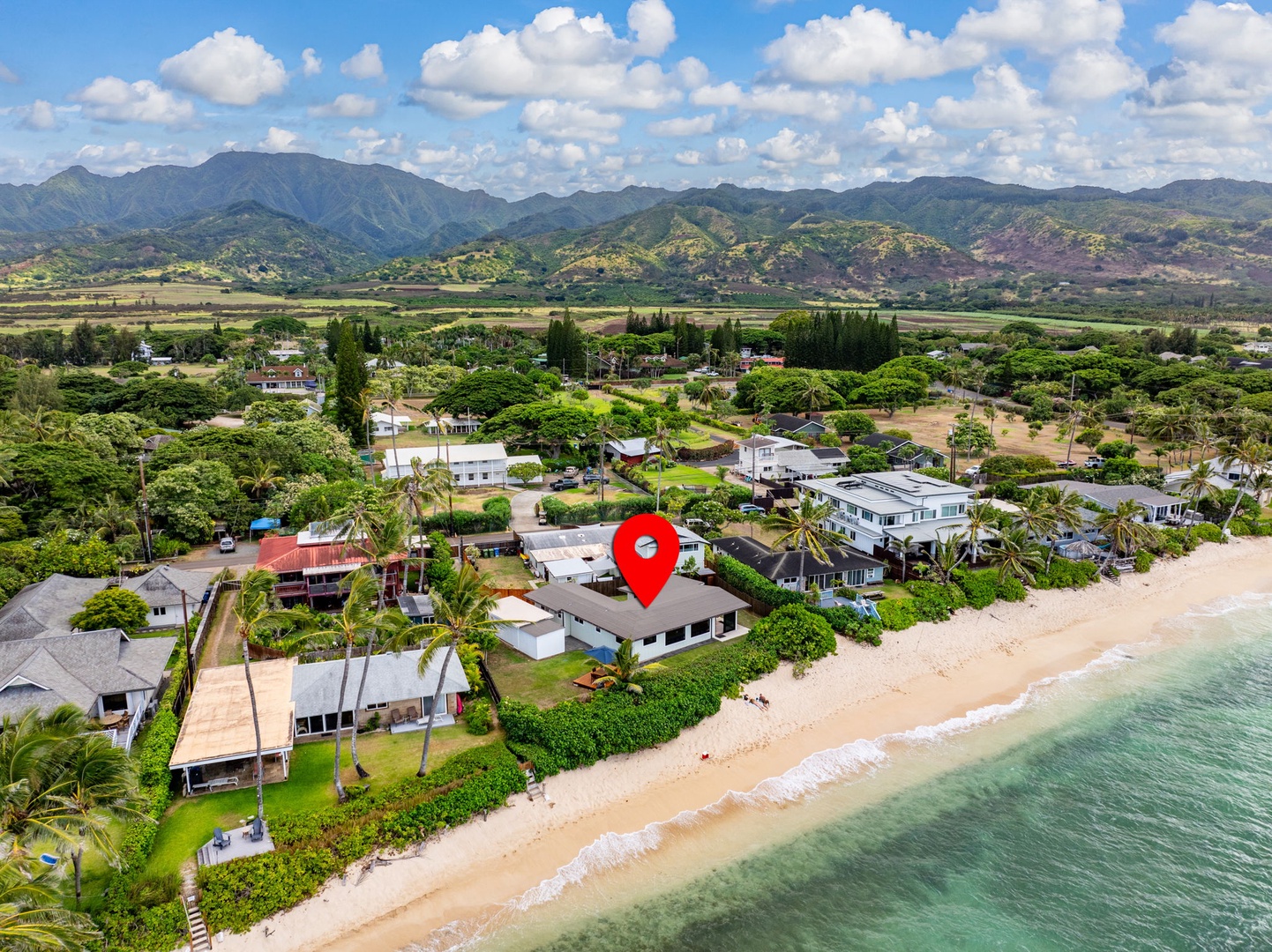 Waialua Vacation Rentals, Mokuleia Beach Villa** - Private beachfront access onto the sandy shores of Mokuleia Beach, known for its calm waters and breathtaking sunsets.