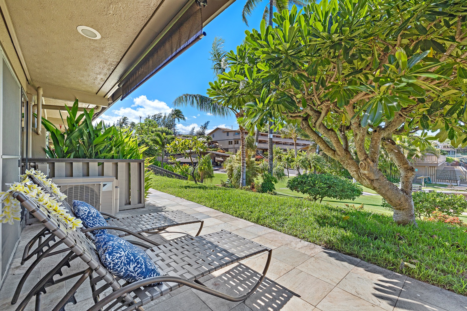 Lahaina Vacation Rentals, Kahana Sunset B4B - Relax on the lanai with comfortable lounge chairs and the perfect spot to enjoy the peaceful island atmosphere.The cozy outdoor dining area is perfect for enjoying meals al fresco, with comfortable seating and a relaxing garden view.