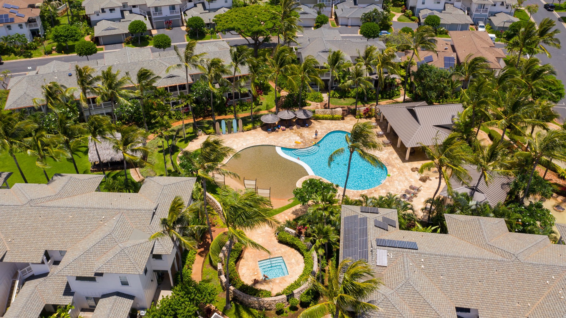 Kapolei Vacation Rentals, Coconut Plantation 1080-4 - The pool anchors the community from above, ringed by lawn and low rooflines.