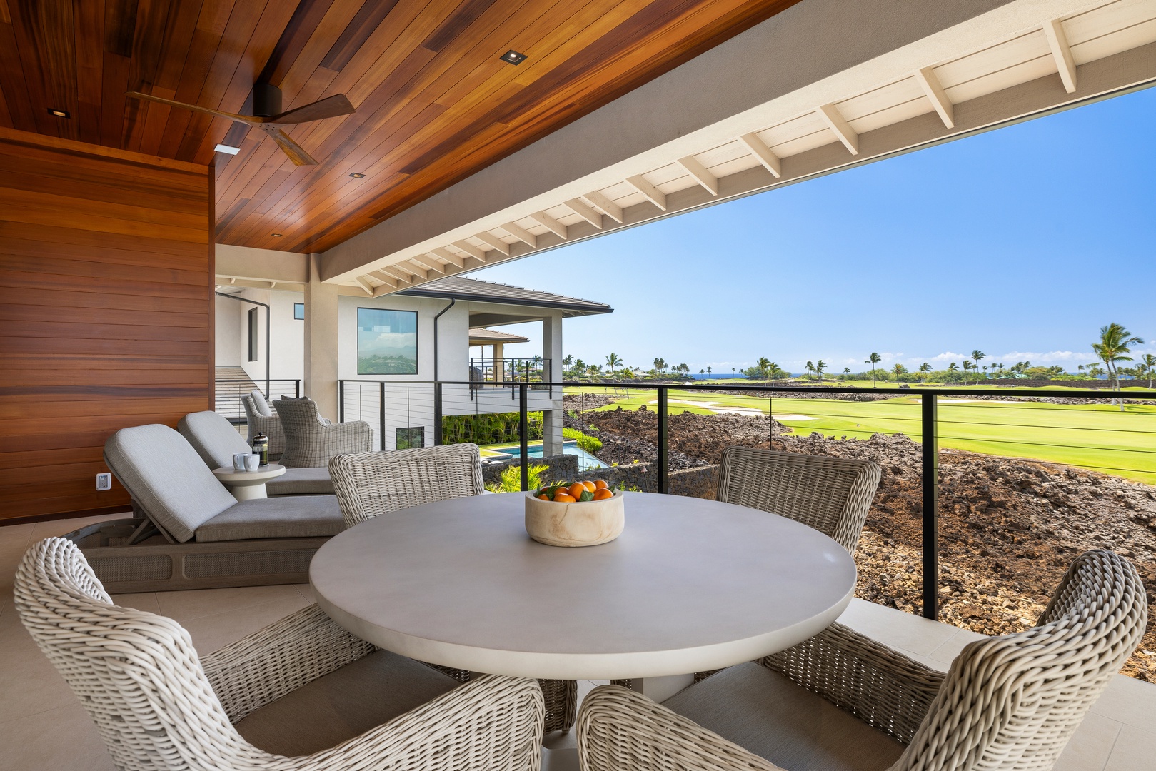 Kamuela Vacation Rentals, 6BD Mauna Lani Lux Golf Estate (5) at One Ocean - Loungers face the green where the light turns gold late in the day.