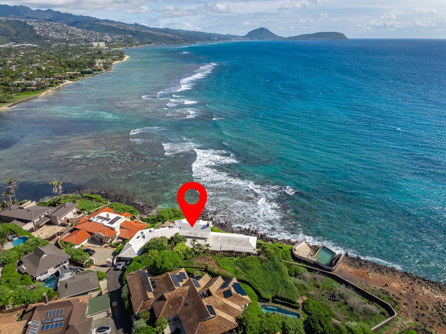 Honolulu Vacation Rentals, Black Point Ocean Villa - Stunning oceanfront location with pristine turquoise waters and dramatic coastline views stretching to distant mountains.