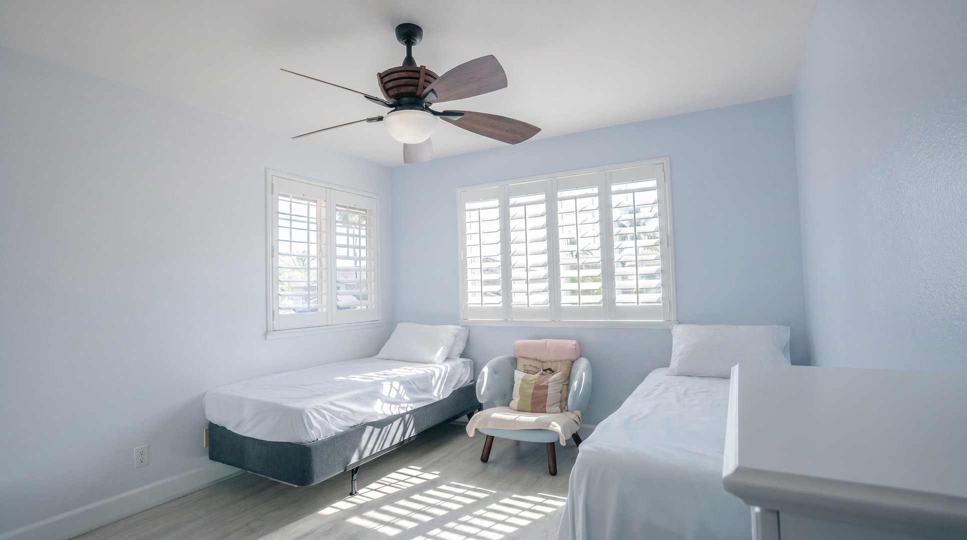 Two twin beds with a reading chair between them, so nobody has to share a bed.