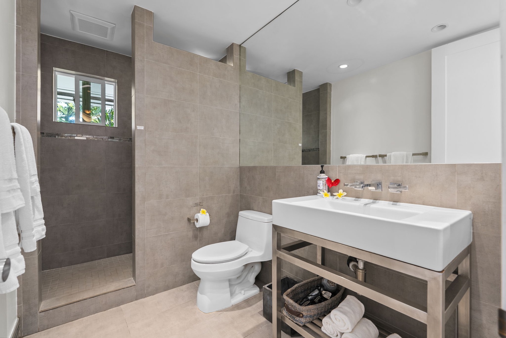 Waianae Vacation Rentals, Ma'ili Blue - Refresh in your modern bathroom with sleek stone finishes, spacious walk-in shower, and thoughtful amenities for your comfort.