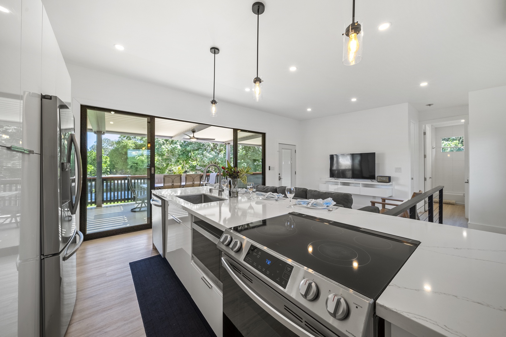 Haleiwa Vacation Rentals, Sunset Beach Island Retreat - This open-concept kitchen is perfect for cooking and entertaining, featuring sleek modern appliances and a spacious island.