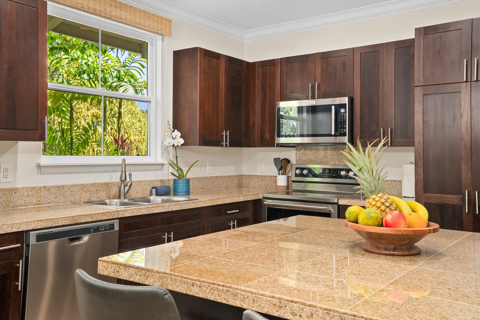Princeville Vacation Rentals, Hale Kaua'i - Gather in the bright kitchen, where tropical views and generous counter space inspire easy island meals.