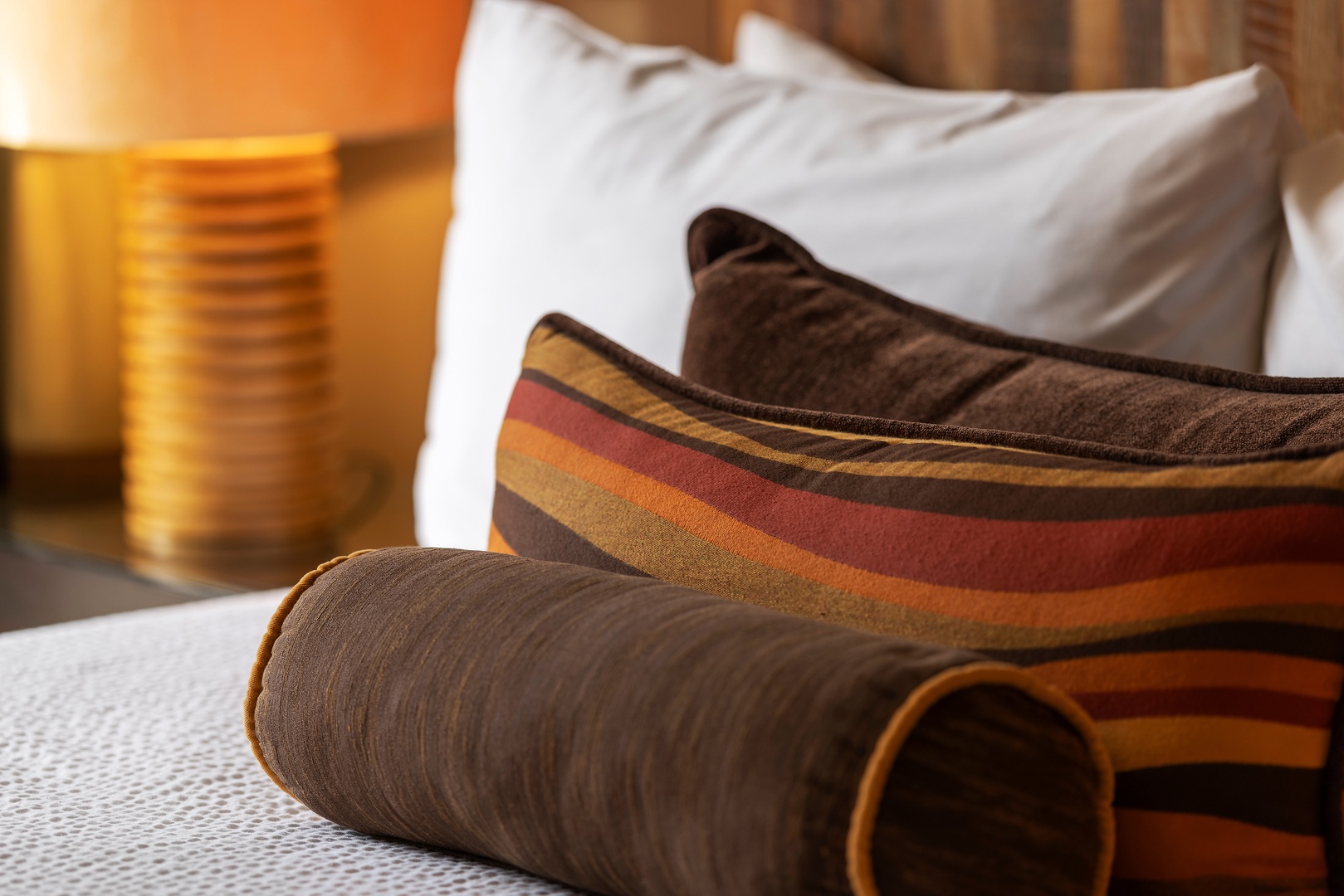 Sink into plush pillows and cozy bedding, where warm earth tones and soft textures invite you to unwind after a day of exploring.