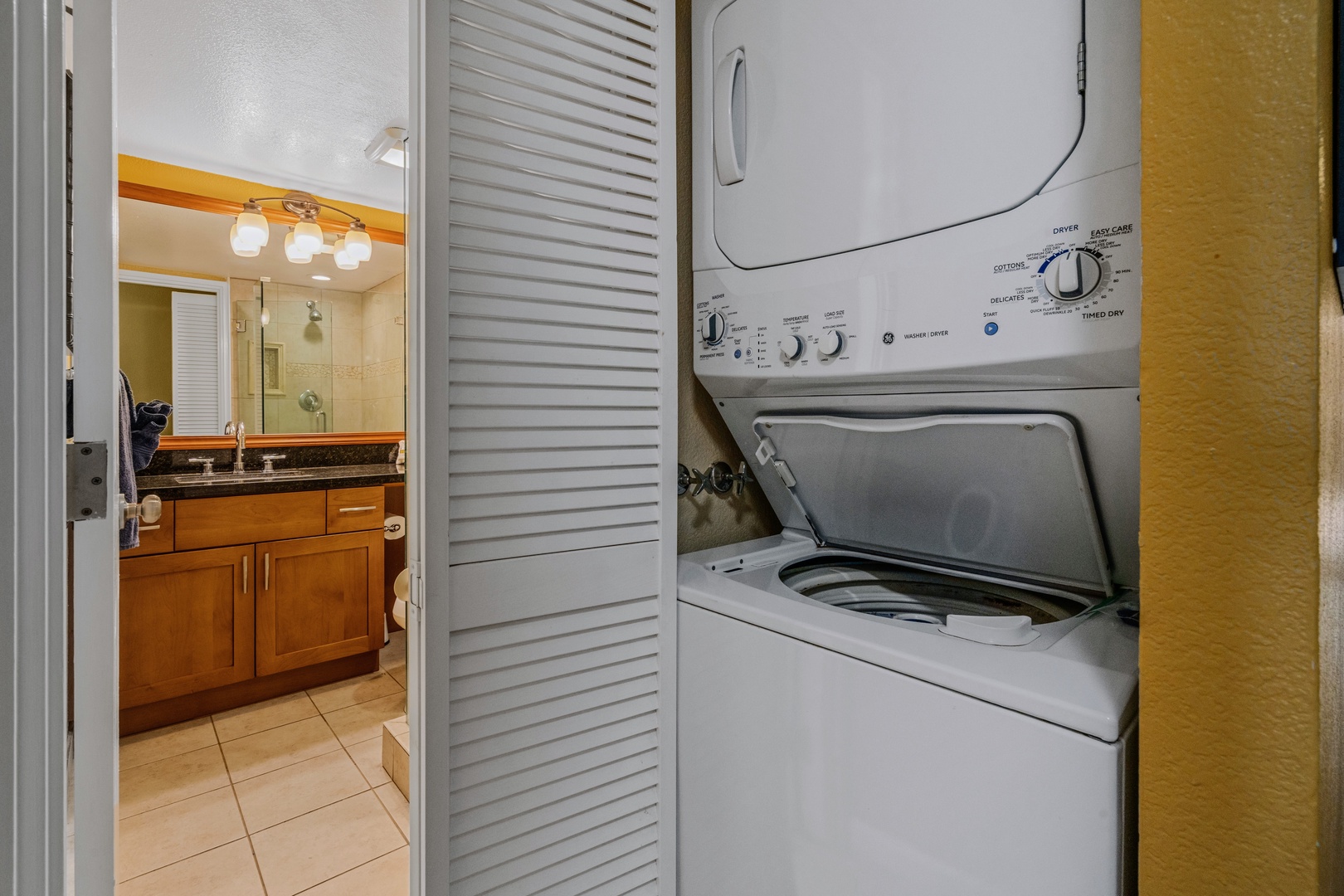 Kihei Vacation Rentals, Kamaole Sands 5310 - Beach towels get the sand rinsed out right here, stacked washer and dryer tucked into their own closet.