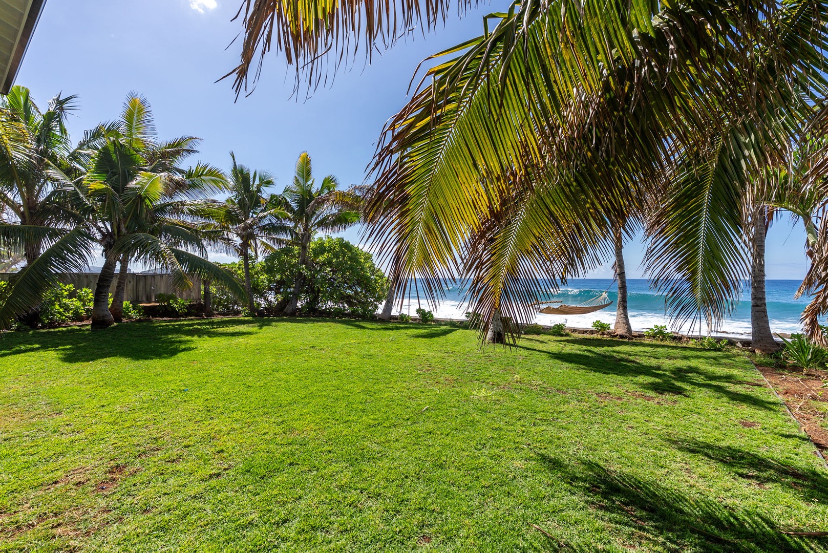Waianae Vacation Rentals, Oceanfront Luxury Dream Estate - This view showcases the generous scale of the yard, perfect for relaxing or entertaining in the sun.