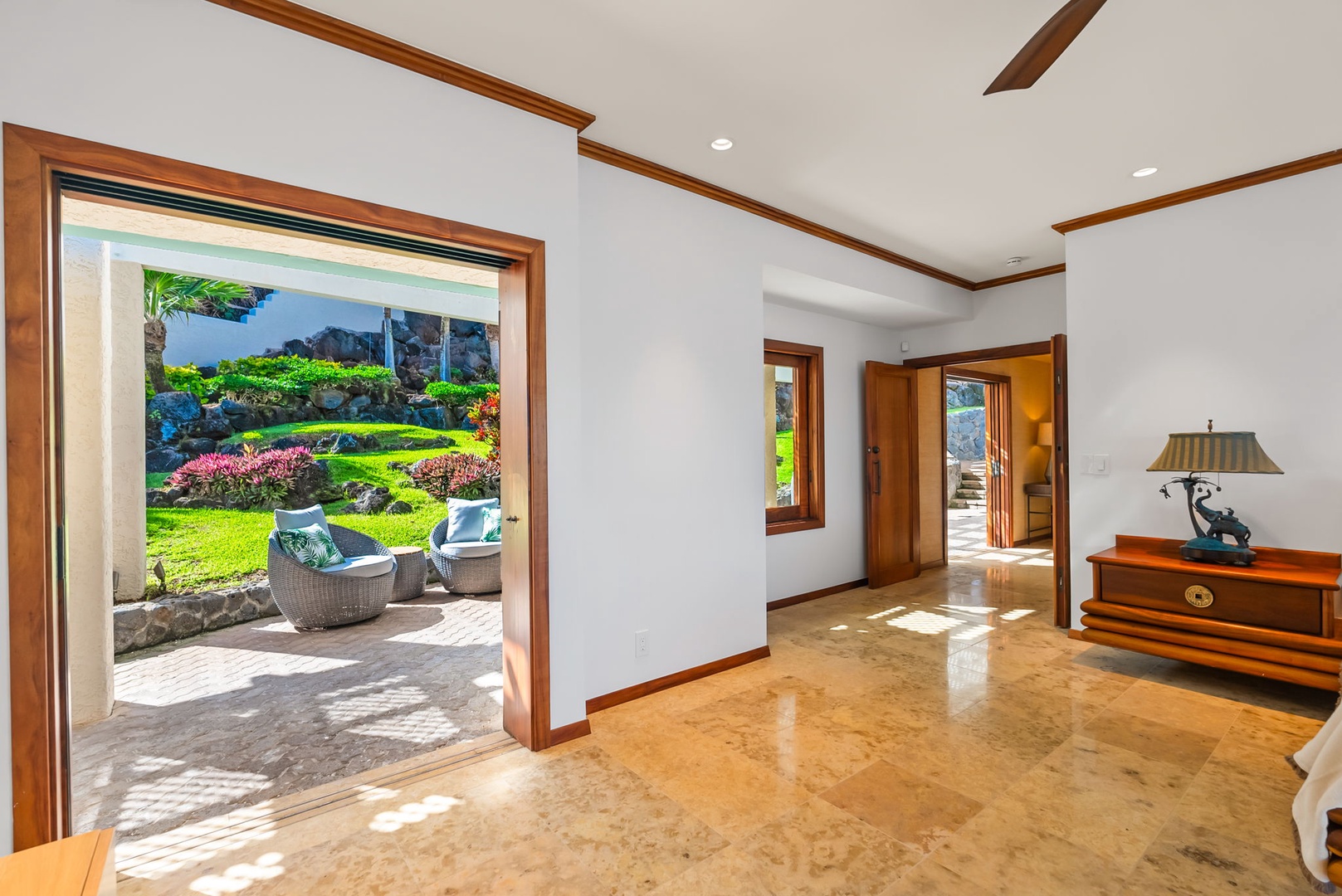 Honolulu Vacation Rentals, Black Point Ocean Villa - Rich wood trim frames stunning garden views through floor-to-ceiling doors.
