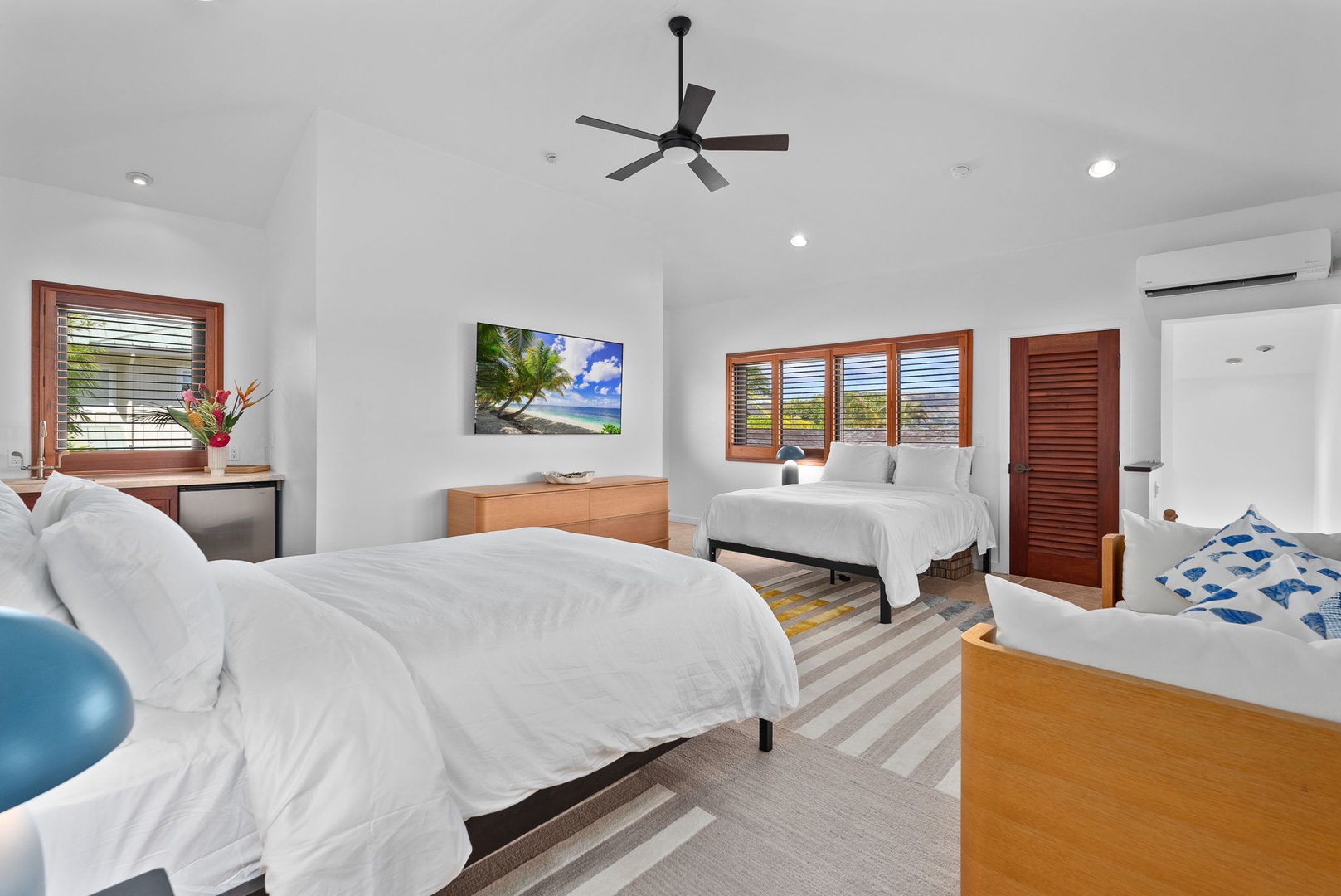 Honolulu Vacation Rentals, Honolulu Lagoonfront Villa - Wake to soft natural light in this airy guest suite, featuring two queen beds, garden-view windows, and plenty of space to unpack and settle in.