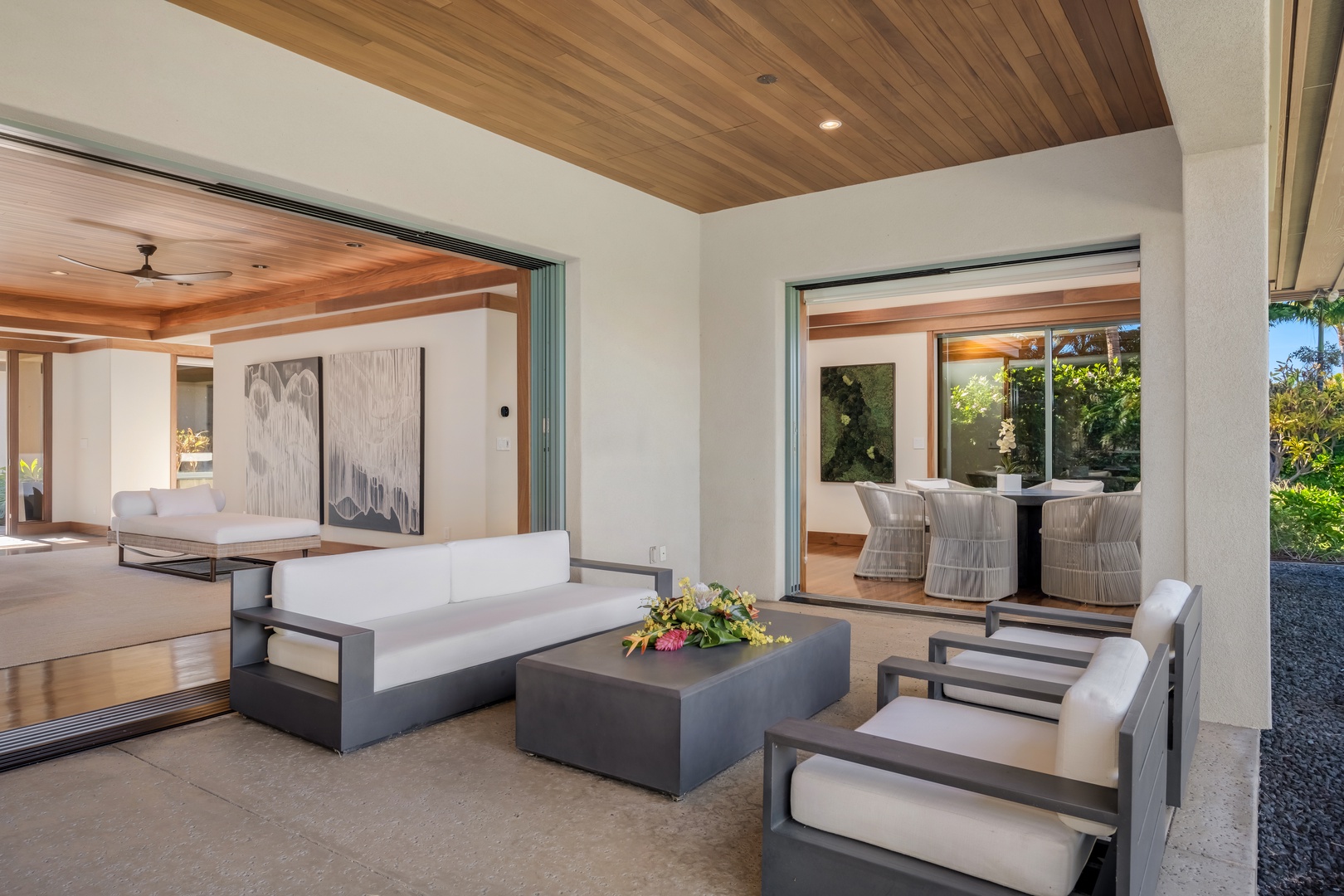 Kamuela Vacation Rentals, Champion Ridge Elegance - Covered outdoor lounge area with plush seating, ideal for enjoying the fresh island air and stunning views of the Kohala Mountains and surrounding tropical landscape..