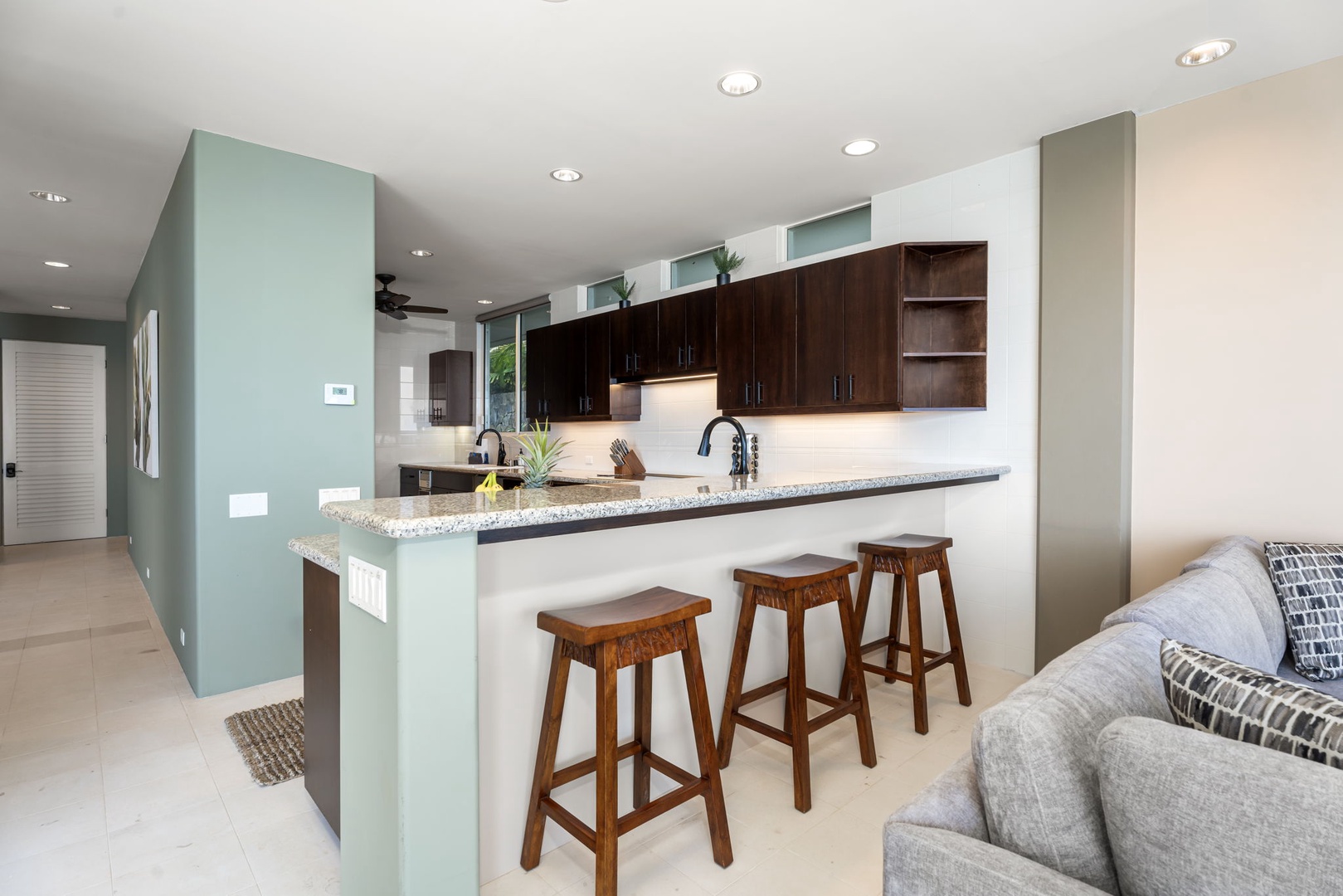 Kailua Kona Vacation Rentals, Hale Nai'a - Your modern kitchen features granite countertops, bar seating for three, and sleek dark cabinets for all your cooking needs.