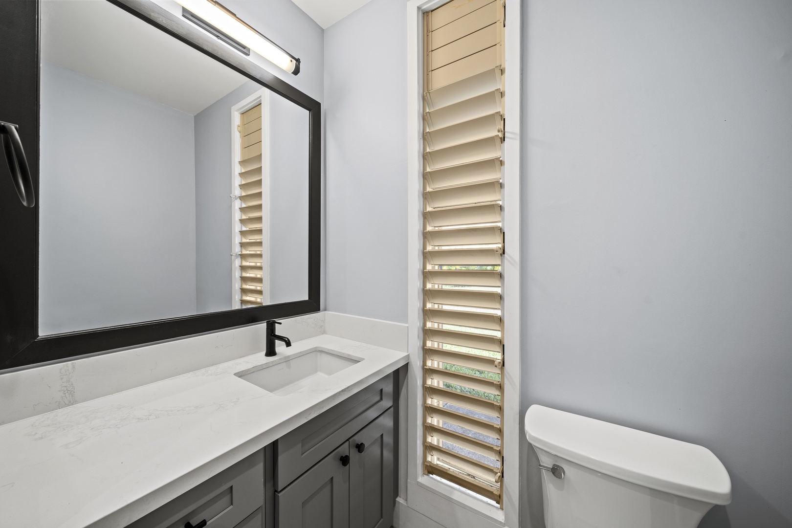 Haleiwa Vacation Rentals, Hale Mahina - Start the day at a sleek vanity with modern fixtures and clean, bright finishes.