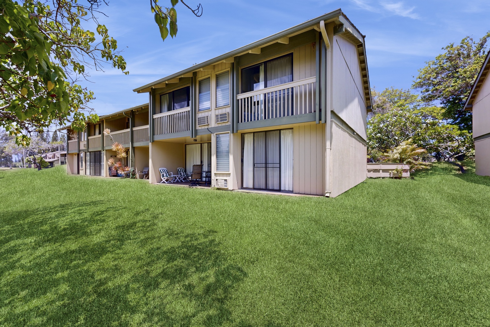 Kahuku Vacation Rentals, Kuilima Estates West #132 - Rear building view with wide grassy lawn.