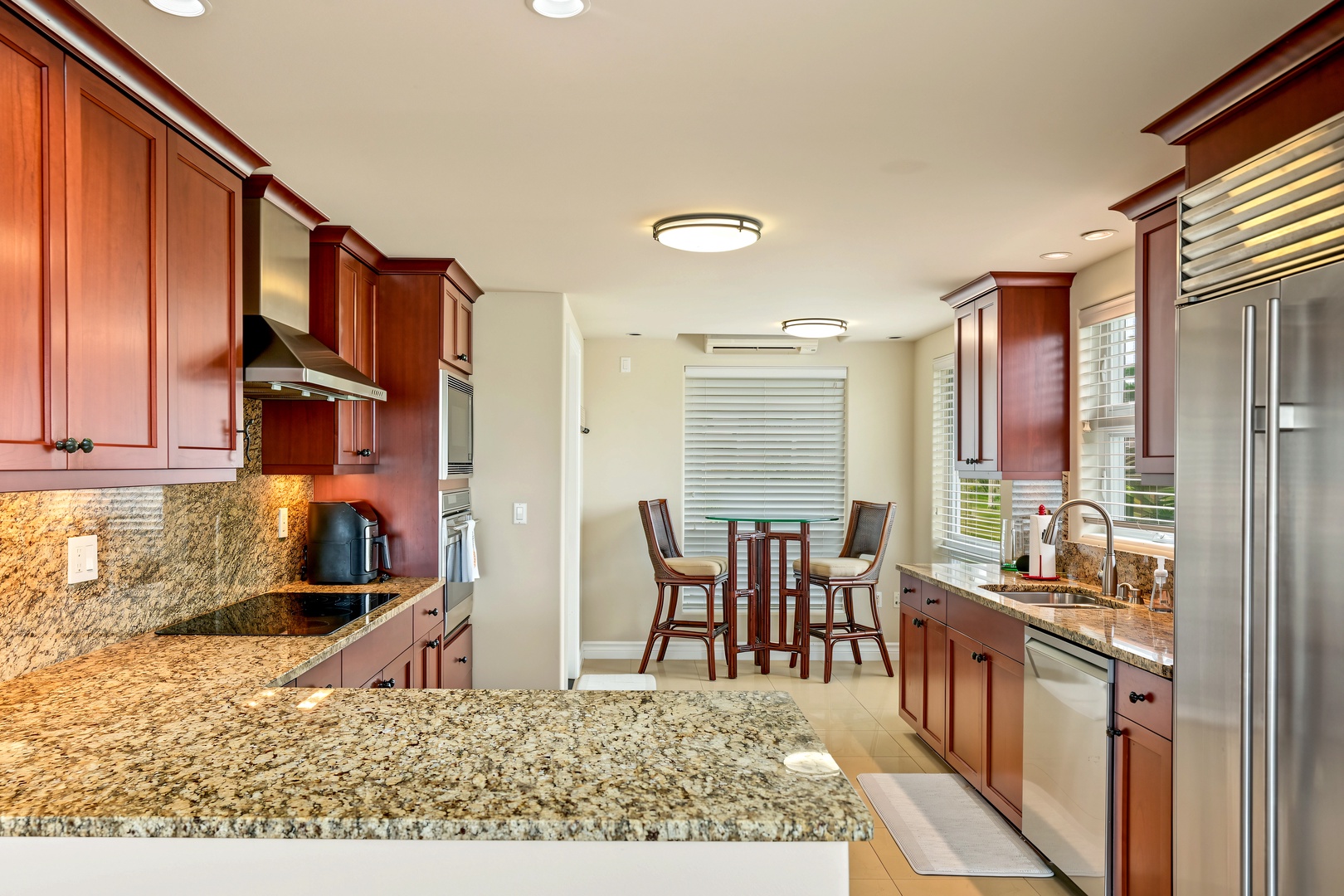 Princeville Vacation Rentals, Hale Hau'oli Moku - Pull up a chair at the bar-height table in the window nook while someone else cooks.