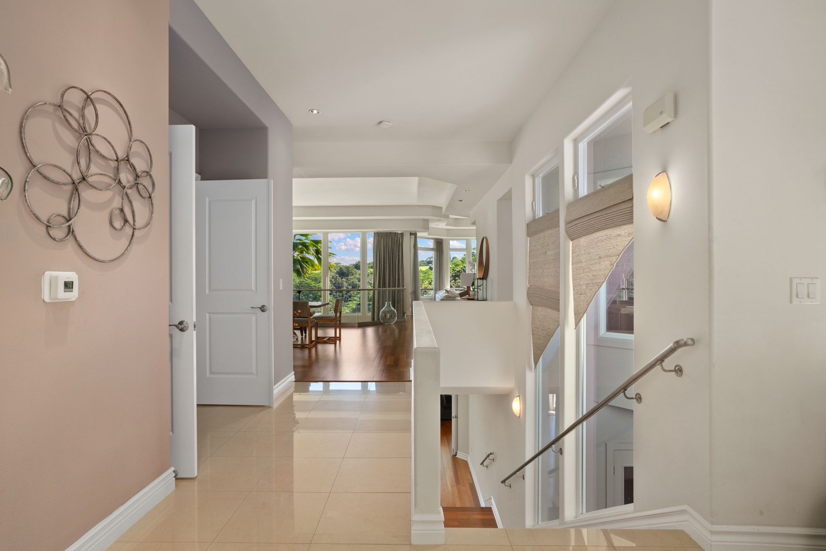 Princeville Vacation Rentals, Kaiulani #8 - Head down the staircase toward the lower level, daylight following from above.