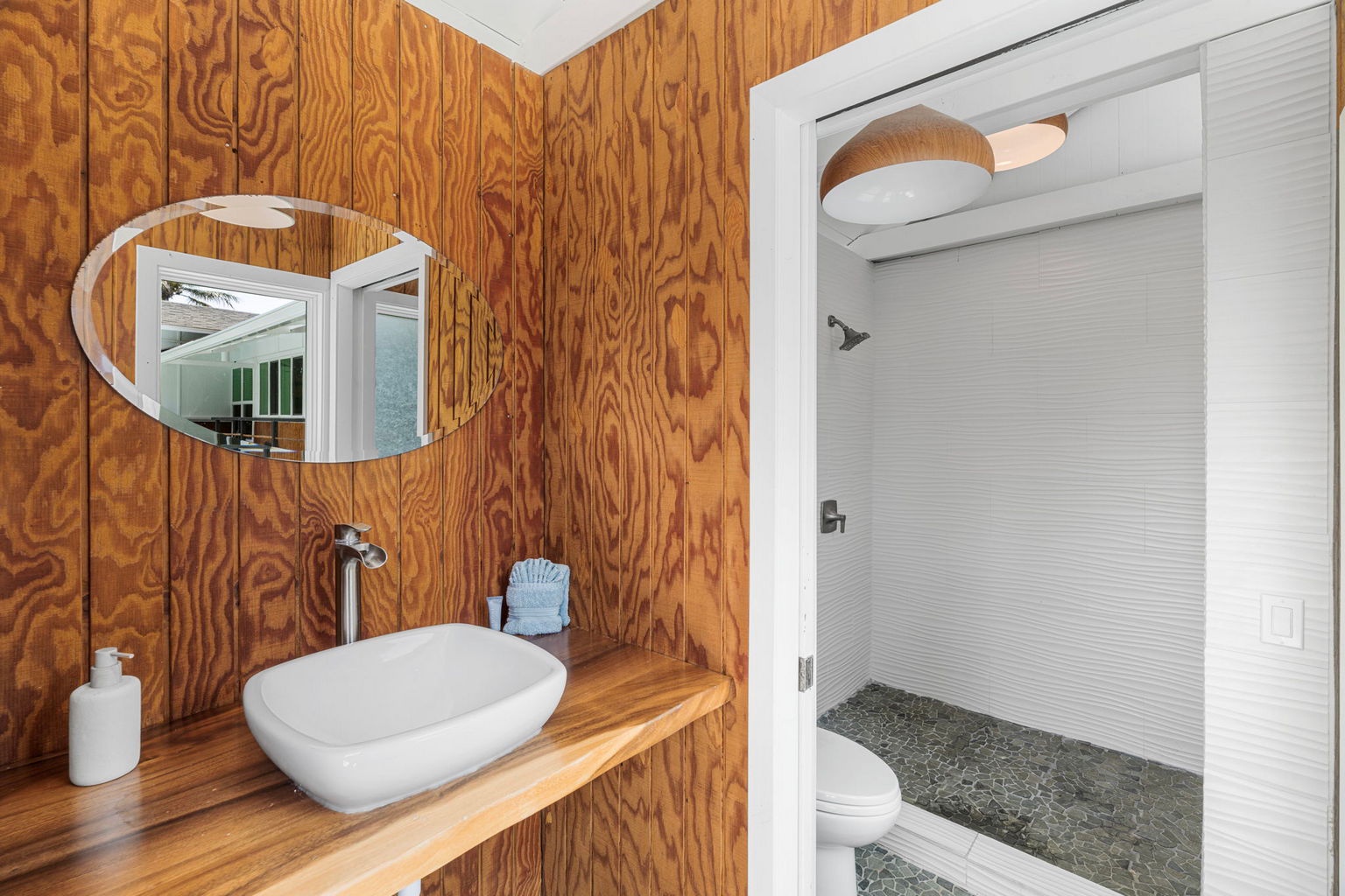 Kailua Kona Vacation Rentals, Manukai Hale - A wood-paneled bathroom tucked alongside the pool