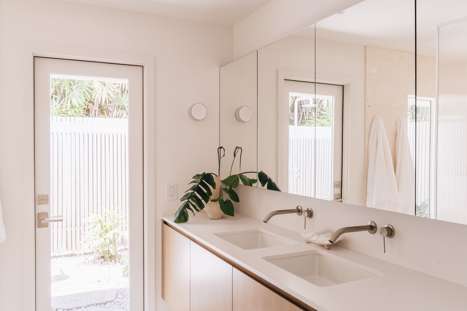 Honolulu Vacation Rentals, Surfside Bungalow** - Bright and modern, this spacious bathroom features dual vanities and clean, contemporary finishes.