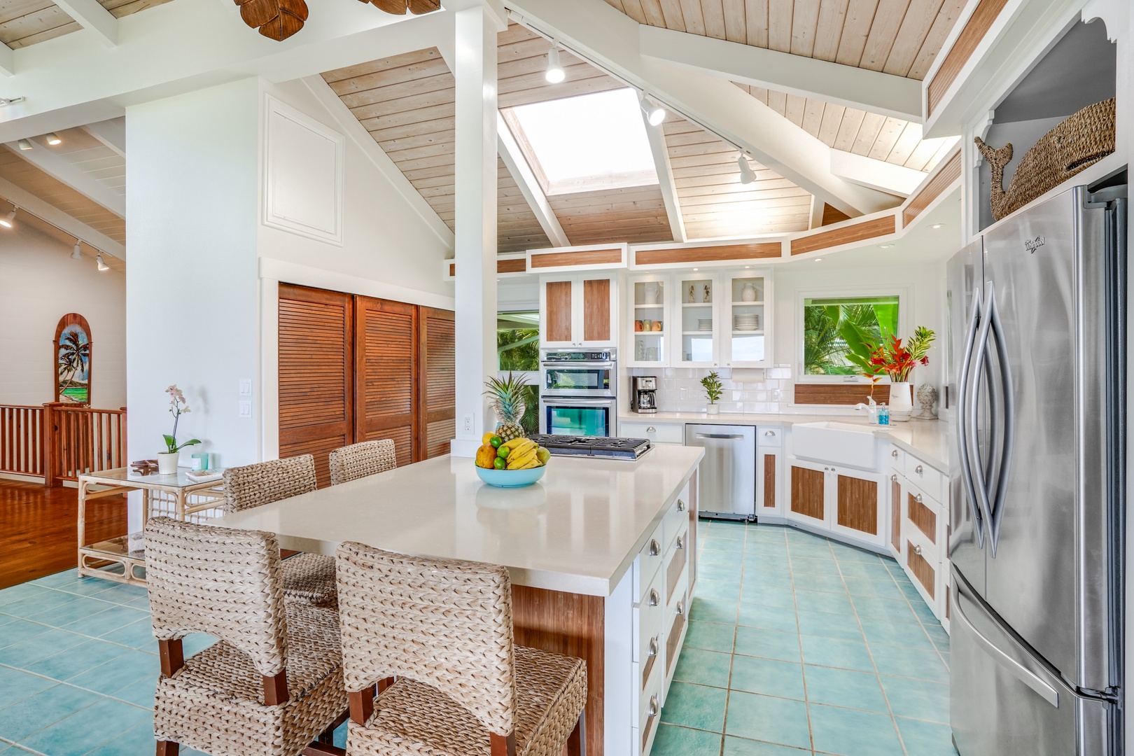 Princeville Vacation Rentals, Wai Lani - Under the majestic sweep of vaulted ceilings, our kitchen and dining area invite you to savor every moment and every meal.