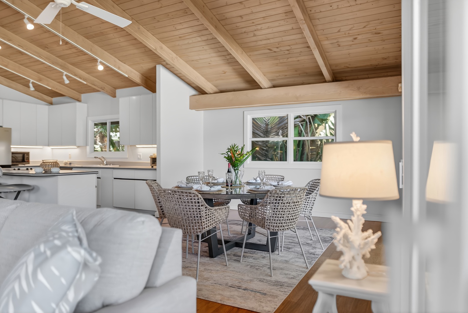 Haleiwa Vacation Rentals, Sunset Beach Hideaway - Relax in this bright, airy living space with soaring wood-beamed ceilings, a sleek modern kitchen, and elegant dining area perfect for your coastal retreat.
