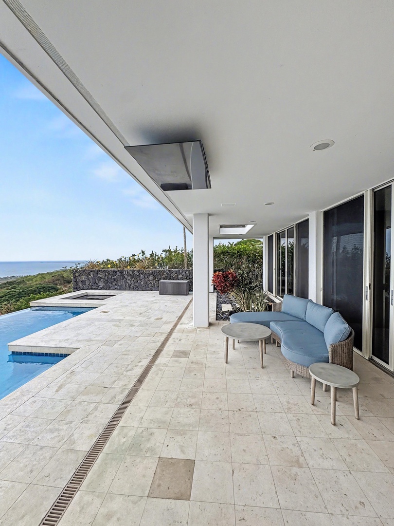 Kailua Kona Vacation Rentals, Hale Nai'a - Covered lanai with pool access, relaxed seating, and open views toward the horizon.