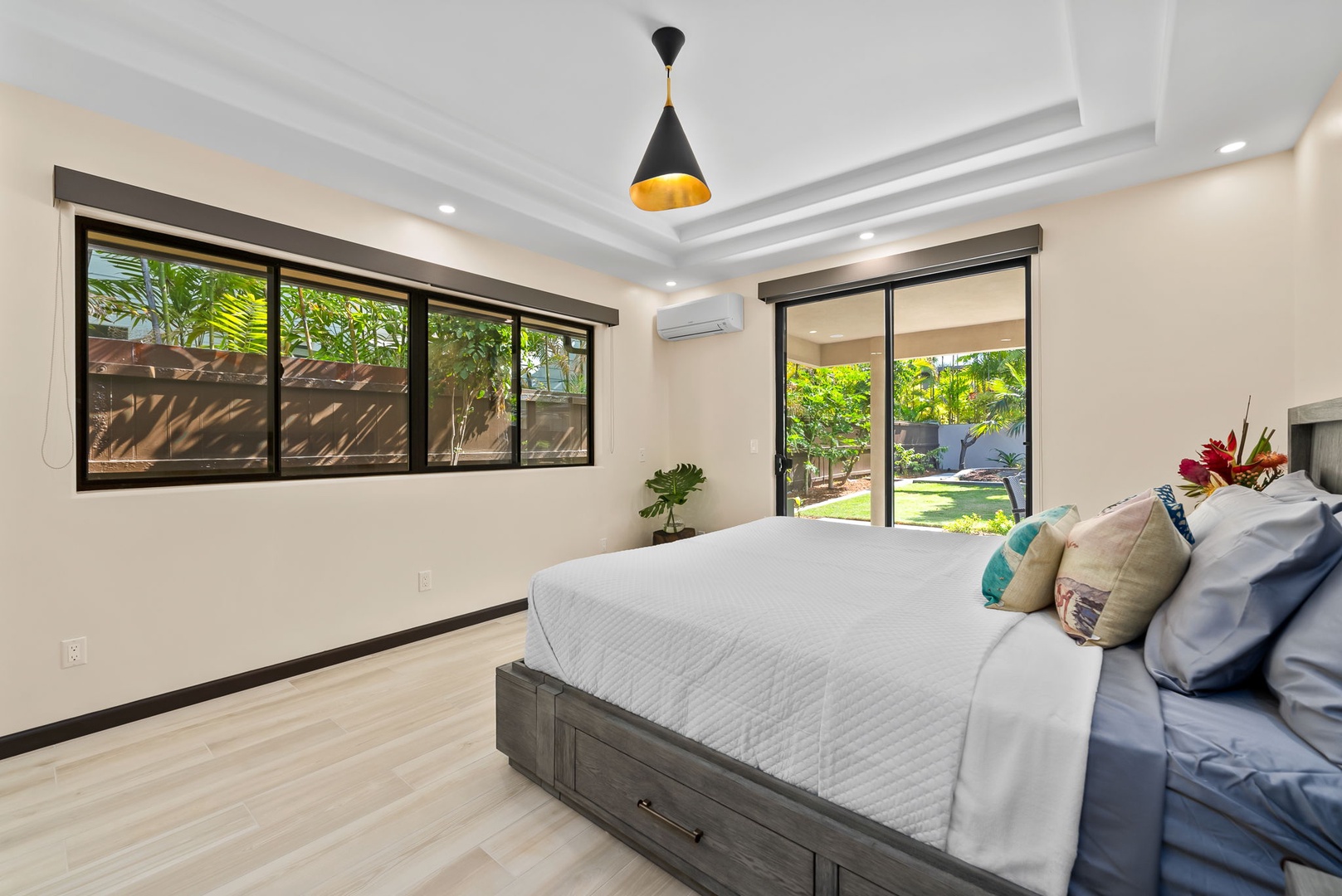 Honolulu Vacation Rentals, Kahala Zen - Spacious bedroom with a queen-size bed and lush garden views.