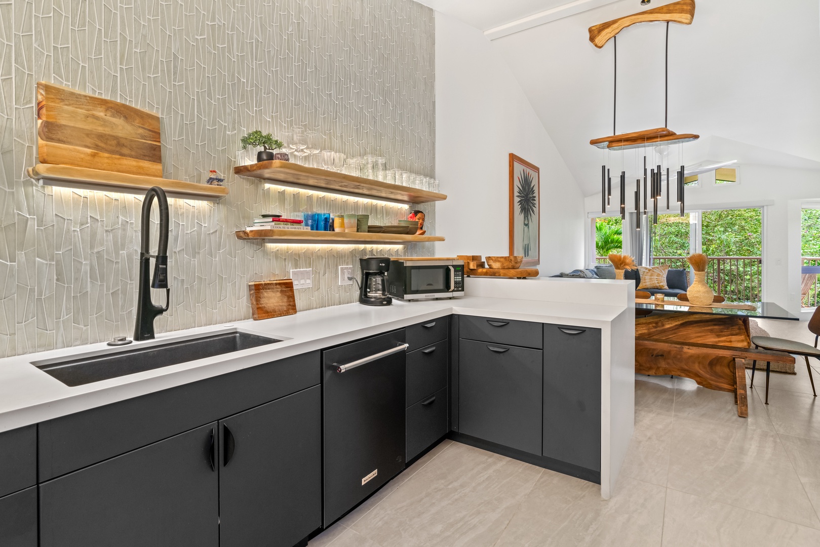 Princeville Vacation Rentals, Mana Wahine - Live-edge shelving and black matte cabinetry bring style and function to the kitchen.