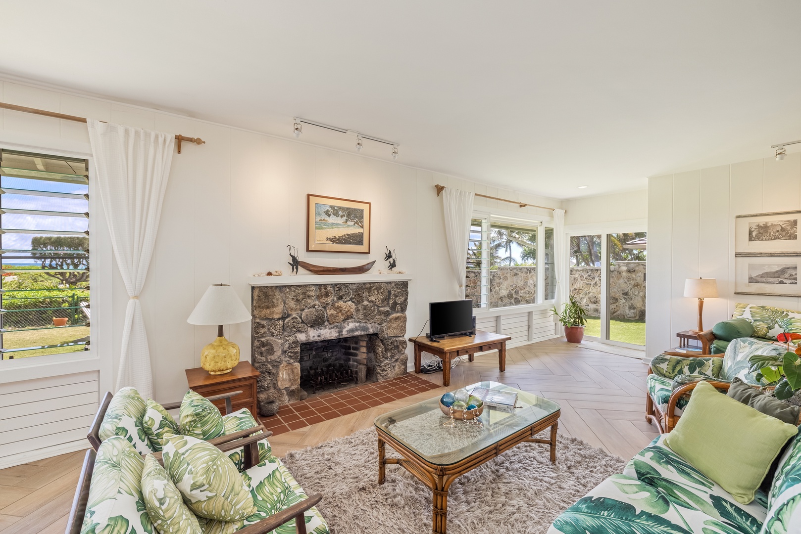 Kailua Vacation Rentals, Hale Moana Lanikai - Cozy up in this inviting corner of the home, featuring a charming stone fireplace and serene garden views through the large windows