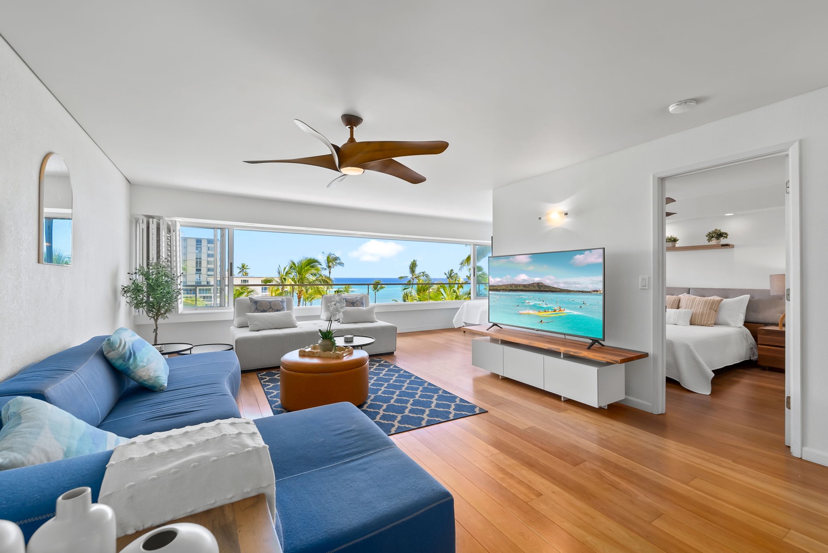 Honolulu Vacation Rentals, Colony Surf Retreat - Enjoy island relaxation in this spacious living area, with ceiling fan comfort and vibrant coastal decor—ideal for unwinding after beach days.