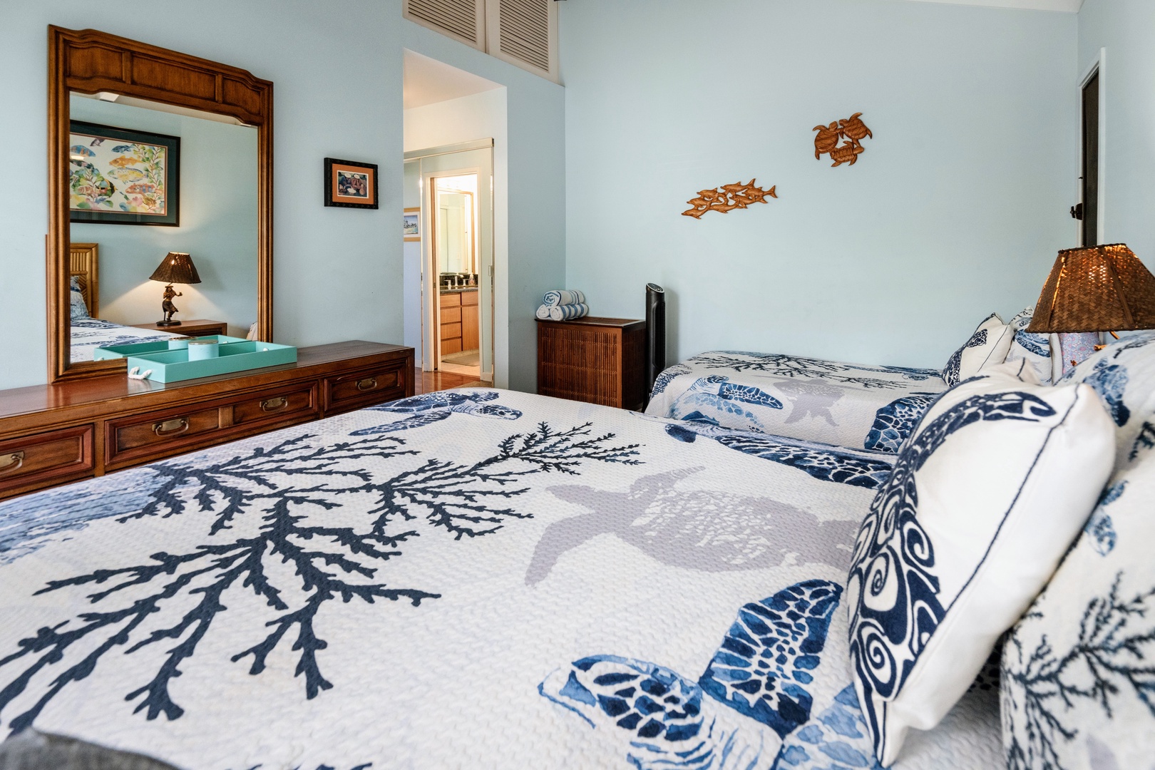 Kihei Vacation Rentals, Wailea Ekolu 204 - Wood turtle carvings swim across the wall above the dresser, with an ensuite bath just through the door.